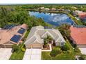Aerial view of home showcasing the pool, landscaping, and nearby lake at 10228 Estuary Dr, Tampa, FL 33647