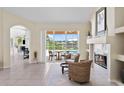 Bright living room with fireplace, tile floors, and sliding doors to the patio at 10228 Estuary Dr, Tampa, FL 33647