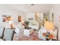 Cozy living area with two sofas, decorative rug, and staircase in background at 18187 Paradise Point Dr, Tampa, FL 33647