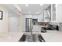 Bright kitchen featuring white cabinets, stainless steel appliances, and attractive backsplash at 201 W Laurel St # 702, Tampa, FL 33602