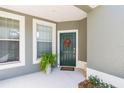 Charming entryway with a green front door, sidelight window, and decorative wreath at 2211 Kings Palace Dr, Riverview, FL 33578