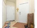 Neutral entryway featuring a large front door and interior closet at 2211 Kings Palace Dr, Riverview, FL 33578