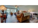 Inviting living room featuring sliding glass doors, a ceiling fan, and comfortable seating at 225 Country Club Dr # 1104, Largo, FL 33771