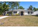 Charming single-story home featuring lush landscaping and a well-maintained lawn at 331 Barbara Cir, Belleair, FL 33756
