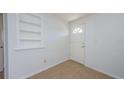 Bright foyer showcases clean white walls, neutral tiled flooring, and a classic paneled door, creating an inviting entry at 3815 Bowen St, New Port Richey, FL 34652
