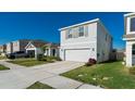 Two-story home featuring a two-car garage, neutral paint, and well-maintained landscaping at 5571 Birch River Trl, Wesley Chapel, FL 33545