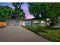 Charming single story home with a well-manicured lawn and mature trees at 5907 Tampa Shores Blvd, Tampa, FL 33615