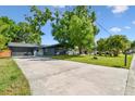 Charming single story home with a well-manicured lawn and mature trees at 5907 Tampa Shores Blvd, Tampa, FL 33615