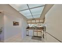 Bright kitchen with a skylight and white cabinetry, seamlessly connecting to the living spaces at 6123 113Th St # 510, Seminole, FL 33772