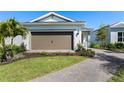 Beautiful single-Gathering home boasts a paved driveway and a well-maintained front yard at 6132 Wire Grass Ct, Nokomis, FL 34275