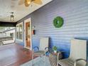 Charming covered porch with cozy seating, a decorative wreath, and a stylish rug, perfect for relaxing at 714 W Peninsular St, Tampa, FL 33603