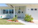 Inviting front porch with a decorative wreath, seating, and landscaping, perfect for welcoming guests at 731 44Th Ne Ave, St Petersburg, FL 33703