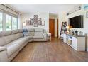 Comfortable living room featuring a large sectional sofa, wood-look tile flooring, and modern decor at 731 44Th Ne Ave, St Petersburg, FL 33703