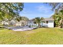 Charming single-story home with light blue exterior and well-maintained lawn complemented by landscaping and neighboring houses at 747 39Th Ne Ave, St Petersburg, FL 33703