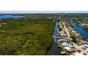Aerial view showcases a waterfront property with canal access, lush surroundings, and neighborhood at 9409 Sun Isle Ne Dr, St Petersburg, FL 33702