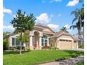 Charming home exterior with manicured lawn, mature landscaping, and inviting curb appeal at 9905 Woodbay Dr, Tampa, FL 33626