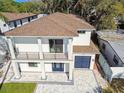 Beautiful modern home featuring a balcony, a large window, and a two-car garage at 1045 Jesse Ave, Safety Harbor, FL 34695