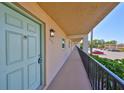 Exterior walkway with a light-blue door in a building with beige siding at 12300 Park Blvd # 202, Seminole, FL 33772