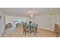 Open-concept living and dining area with plush carpeting and ample natural light at 12300 Park Blvd # 202, Seminole, FL 33772