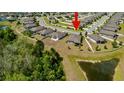 An aerial shot shows the property's location with a pond in a quiet residential neighborhood at 12308 Chaya Ct, Spring Hill, FL 34610
