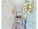 Bright entryway with a stylish rug, console table, and a view into the living area at 12856 French Market Dr, Riverview, FL 33579