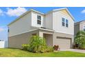 Side view of a two story home with vinyl siding, manicured lawn, and a well-maintained exterior at 12856 French Market Dr, Riverview, FL 33579