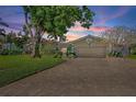 Charming single-story home featuring a brick driveway, manicured lawn and lush landscaping at 1344 Monterey Ne Blvd, St Petersburg, FL 33704