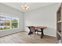 Office space featuring neutral walls, wood-look tile, and natural light at 18185 Cortes Creek Blvd, Spring Hill, FL 34610