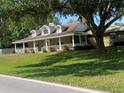 Spacious single-Gathering house with a wraparound porch, perfect for relaxing outdoors at 18724 Geraci Rd, Lutz, FL 33548