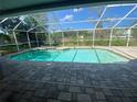 Inviting screened-in pool area, perfect for swimming and outdoor relaxation at 18724 Geraci Rd, Lutz, FL 33548