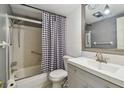 Cozy bathroom with tub, shower, white vanity, and a decorative black and white shower curtain at 1900 59Th N Ave # 108, St Petersburg, FL 33714