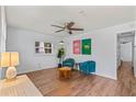 Cozy living room featuring luxury vinyl flooring, ceiling fan, stylish furniture, and natural light at 1906 E Idlewild Ave, Tampa, FL 33610