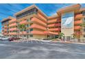 Exterior shot of Bay Mariner condo, featuring well-maintained landscaping and ample parking for residents and guests at 19701 Gulf Blvd # 210, Indian Shores, FL 33785