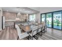Bright and airy dining room featuring an open floor plan with an adjacent modern kitchen and an oversized sliding glass door at 2140 Catalina Dr, Clearwater, FL 33764