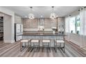 Modern kitchen with white and gray cabinets, granite countertops, stainless steel appliances, and a stylish central island at 2140 Catalina Dr, Clearwater, FL 33764