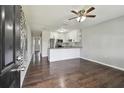 Bright living room with hardwood floors, ceiling fan, and modern black-and-white mural on the wall at 2500 Harn Blvd # B11, Clearwater, FL 33764