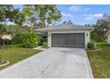 Charming home with a two-car garage, palm tree and well-maintained lawn at 2692 Royal Ridge Dr, Spring Hill, FL 34606