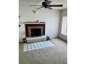Living room with fireplace, ceiling fan, and neutral carpet at 3005 W 18Th W Ave, Bradenton, FL 34205