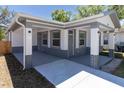 View of the home's exterior, highlighting the covered parking and entrance with accent brickwork at 3205 E North Bay St, Tampa, FL 33610