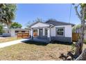 Charming single-story home featuring a covered porch and neatly maintained front yard at 3205 E North Bay St, Tampa, FL 33610