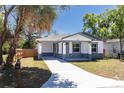 Beautifully renovated single-story home with a fresh lawn and a long driveway leading to the house at 3205 E North Bay St, Tampa, FL 33610