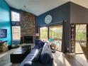 Bright living room with a stone fireplace, patio access, and comfortable seating at 321 Parkside Ln, Safety Harbor, FL 34695