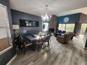 Open-concept living area with wood-look floors, a fireplace, dining area, and abundant natural light at 321 Parkside Ln, Safety Harbor, FL 34695