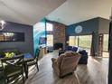 Inviting living room with stone fireplace, high ceilings, and sliding glass doors to the outdoor space at 321 Parkside Ln, Safety Harbor, FL 34695