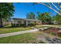 Lovely single-story home with neatly landscaped front yard and walkway at 347 Patica Ne Rd, St Petersburg, FL 33702