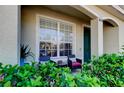 Inviting front porch featuring outdoor seating and decorative plants near the front door at 4676 66Th N Pl, Pinellas Park, FL 33781