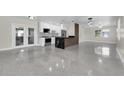Open-concept kitchen with an island, stainless appliances, and easy access to living area and patio at 4812 Wynwood Dr, Tampa, FL 33615