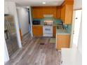 Classic kitchen featuring wooden cabinetry and updated appliances at 5244 Betty St, Zephyrhills, FL 33542