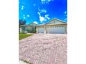 Spacious brick driveway leading to a well-maintained single-story home with a two-car garage at 5525 Thorngrove Way, Spring Hill, FL 34609