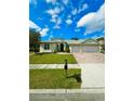 Beautiful single-story home with a well-kept lawn, brick driveway, and a spacious two-car garage at 5525 Thorngrove Way, Spring Hill, FL 34609